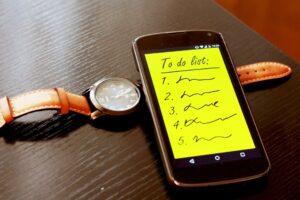 20 tips for selling your home list on smartphone with watch on table